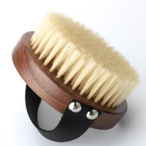 A premium boar bristle brush with a wooden handle, designed to exfoliate and rejuvenate skin for a natural glow.