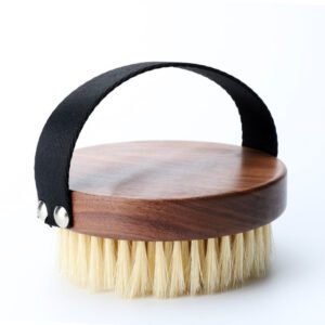 A premium boar bristle brush with a wooden handle, designed to exfoliate and rejuvenate skin for a natural glow.