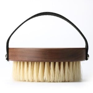A premium boar bristle brush with a wooden handle, designed to exfoliate and rejuvenate skin for a natural glow.