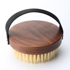 A premium boar bristle brush with a wooden handle, designed to exfoliate and rejuvenate skin for a natural glow.
