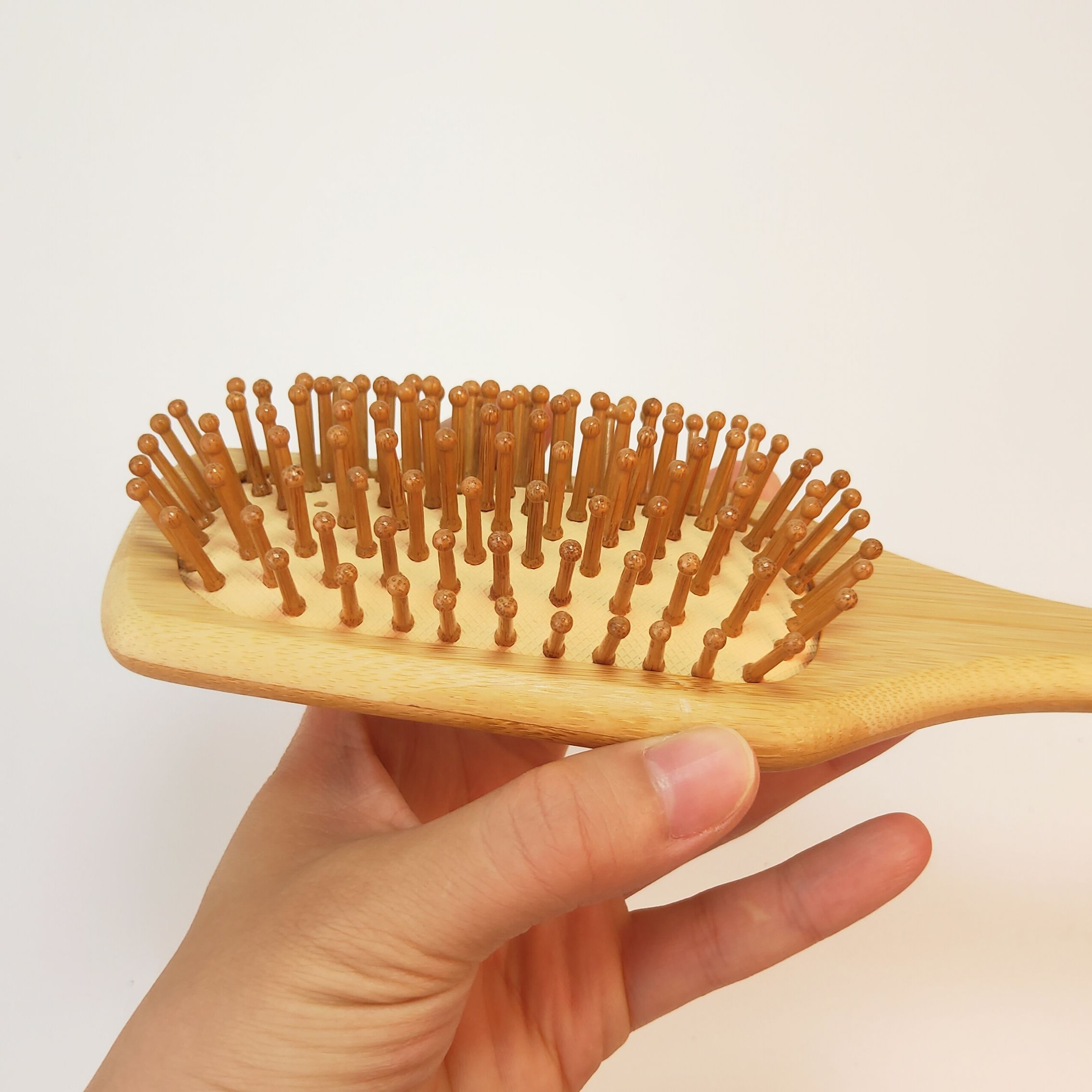 JEYGO Anti-Tangle Hair Brush, featuring a bamboo wooden handle and anti-tangle design, perfect for scalp massage and detangling.