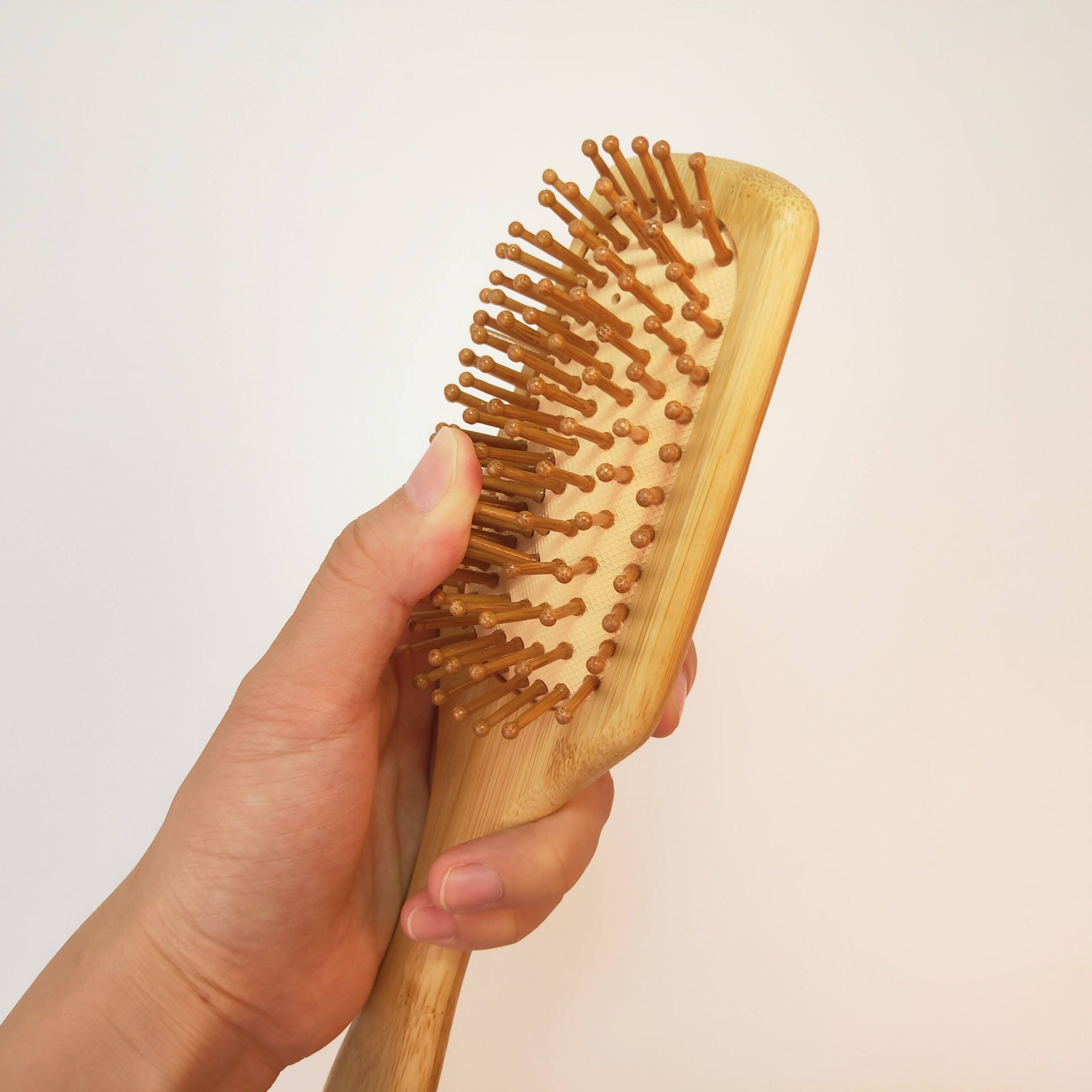 JEYGO Anti-Tangle Hair Brush, featuring a bamboo wooden handle and anti-tangle design, perfect for scalp massage and detangling.