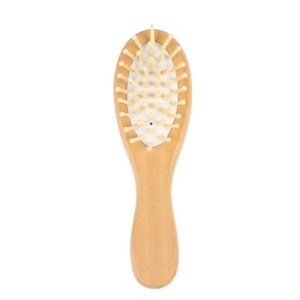 Baby hair brush with wooden handle and soft pins, suitable for gentle scalp care and early hair grooming.