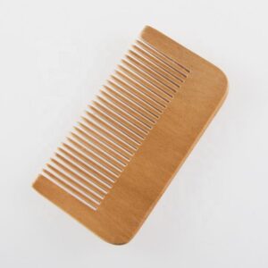 Compact bamboo hair comb with wide teeth and rounded edges, wide tooth wooden comb style for gentle detangling.