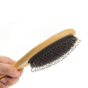 Bamboo hair brush with boar bristles and cushioned base, designed for scalp massage and daily hair care use.