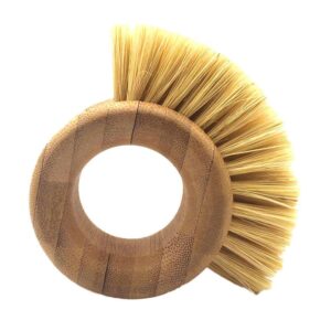 Round bamboo ring-handle kitchen scrub brush with natural sisal bristles on a white background, handheld dish and pot cleaning brush.