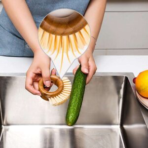 Round bamboo ring-handle kitchen scrub brush with natural sisal bristles on a white background, handheld dish and pot cleaning brush.