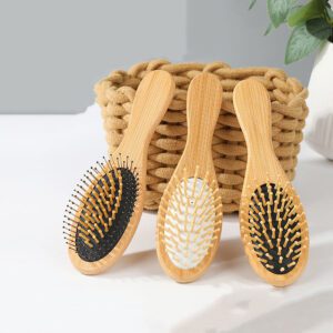 Bamboo paddle hair brush with rubber cushion and wooden handle for gentle scalp massage.