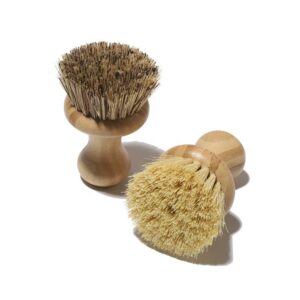 Bamboo-handled round scrubber for kitchen use with natural sisal bristles on a white background