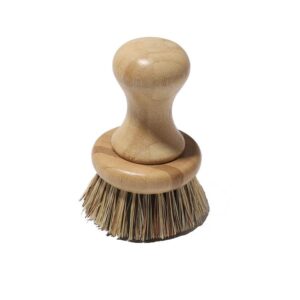 Bamboo-handled round scrubber for kitchen use with natural sisal bristles on a white background