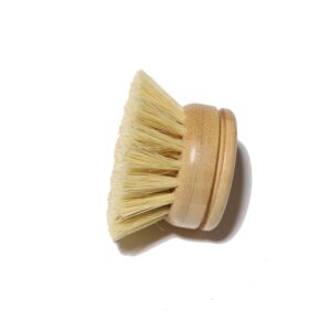 Round bamboo dish brush head with natural sisal bristles photographed on a clean white background