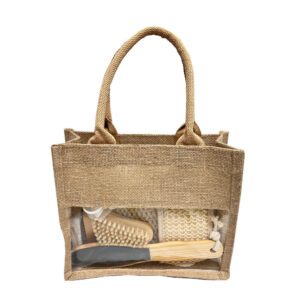 Natural bath and body set with dry body brush, loofah sponges, pumice stone, and more, neatly arranged in a linen handbag.