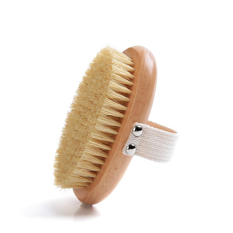 A body brush made of beech wood with boar bristles and a cotton strap, designed for skin exfoliation and dry brushing.