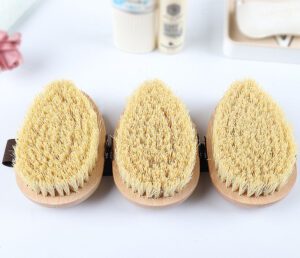 A high-quality boar bristle brush with a wooden handle, designed for effective exfoliation and skin rejuvenation.