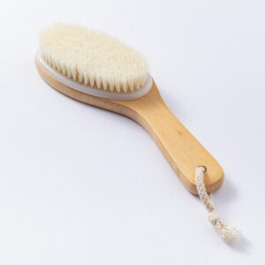 A natural wood brush with soft bristles, designed for gentle exfoliation and improving skin health.