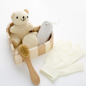 Body care gift set displayed in a wooden bath and body gift box with brush, loofah, pumice stone, towel, and teddy bear decoration.