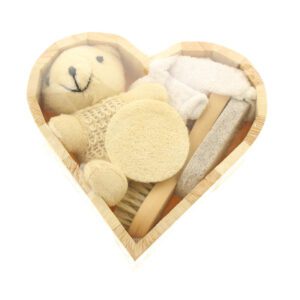 Body care gift set displayed in a wooden bath and body gift box with brush, loofah, pumice stone, towel, and teddy bear decoration.