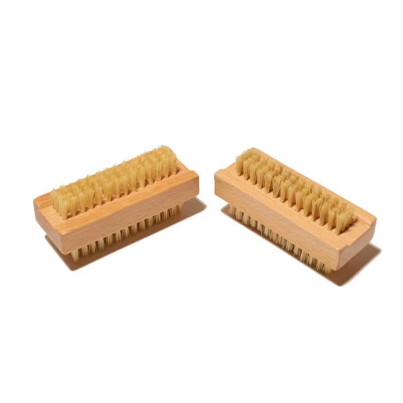 Bamboo nail scrub brush with natural boar bristles for cleaning nails, featuring ergonomic handle design.