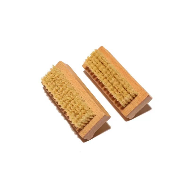 Bamboo nail scrub brush with natural boar bristles for cleaning nails, featuring ergonomic handle design.