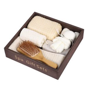 Body care gift set arranged in a wooden box with shower accessories, loofah, brush, sponge, towel, and pumice stone.