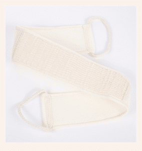 Body care gift set arranged in a wooden box with shower accessories, loofah, brush, sponge, towel, and pumice stone.