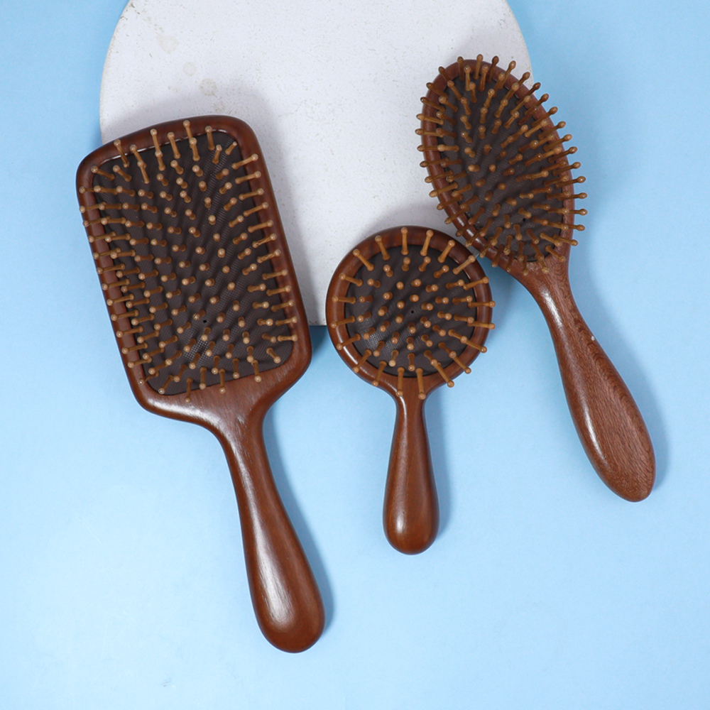 Sandalwood wooden massage comb with air cushion base, designed for head and scalp massage during daily hair care.