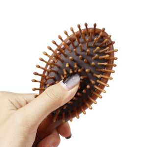 Sandalwood wooden massage comb with air cushion base, designed for head and scalp massage during daily hair care.
