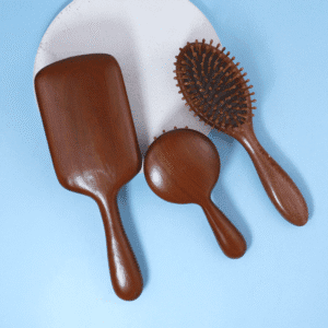 Sandalwood wooden massage comb with air cushion base, designed for head and scalp massage during daily hair care.