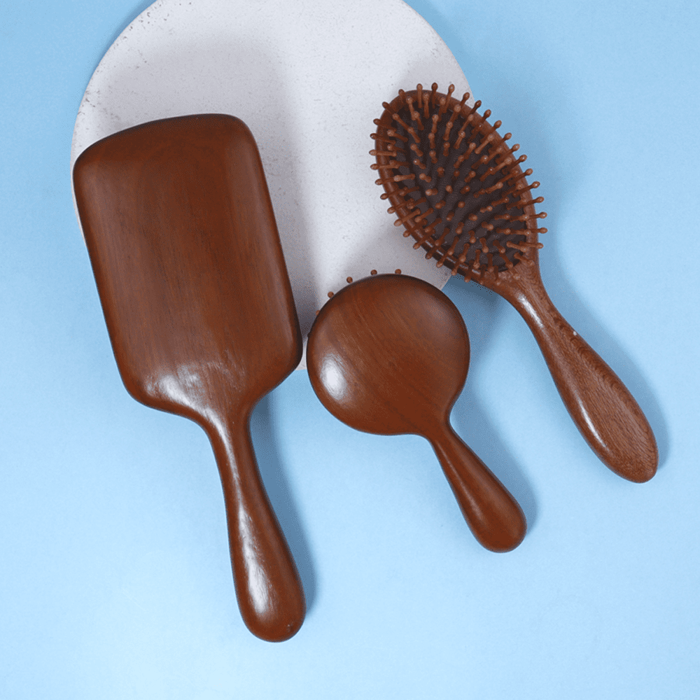 Sandalwood wooden massage comb with air cushion base, designed for head and scalp massage during daily hair care.