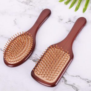 Large wooden paddle massage comb with rounded pins, designed for scalp stimulation and smooth daily hair brushing.