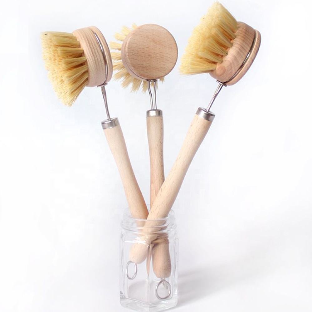 Long-handle wooden dishwashing brush with light bamboo handle, stainless steel neck, and round sisal bristle head on white background.