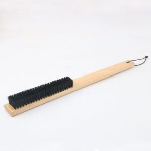 Long-handled brush with wooden handle and black bristles, shoe cleaning brush for removing dust and dirt from shoes.