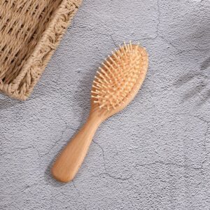 Massage comb with beech wood handle and hard rubber cushion, designed for scalp stimulation and daily grooming.