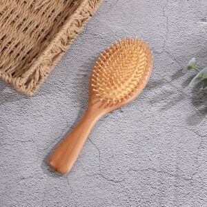 Massage comb with beech wood handle and hard rubber cushion, designed for scalp stimulation and daily grooming.