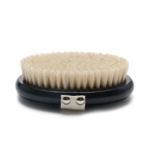 A sleek bath brush with handle, designed for exfoliating dry skin and promoting smooth, healthy skin.