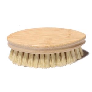 Two oval wooden dishwashing brushes with natural sisal bristles, one bamboo-toned and one beech-toned, shown on a white background.