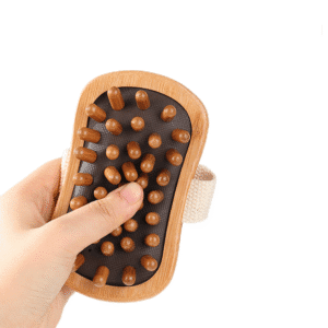 Handheld beech-wood scalp massager brush with rounded rubber massage nodes and a woven strap for comfortable grip.