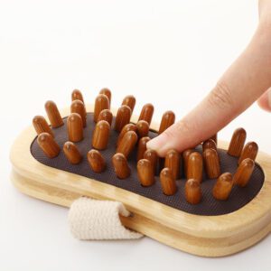 Handheld beech-wood scalp massager brush with rounded rubber massage nodes and a woven strap for comfortable grip.