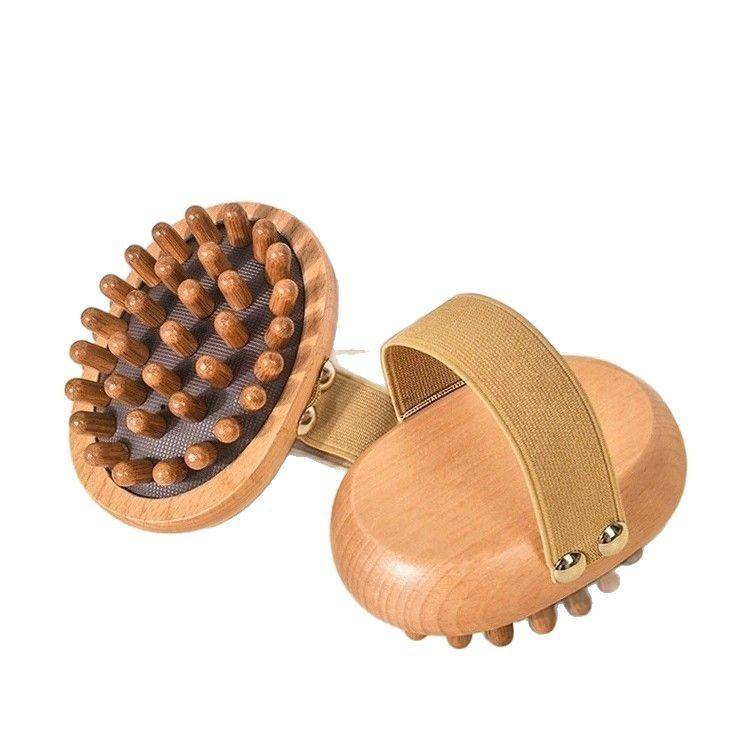 Oval-shaped wooden bath and scalp massage brush with elastic hand strap and multiple rounded massage nodes, produced by a China-based bath brush manufacturer.