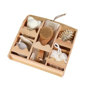 Spa gift set arranged in a wooden organizer with bath accessories, brushes, sponge, pumice stone, and body care tools.
