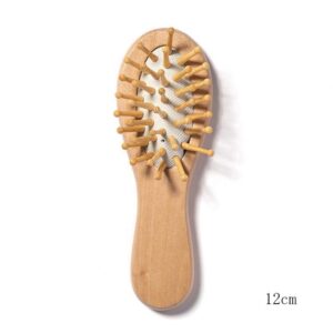 Small wooden hair brush for children with airbag cushion and rounded massage pins.