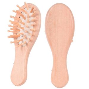 Small wooden hair brush for children with airbag cushion and rounded massage pins.
