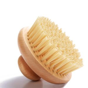 Handheld wooden kitchen scrub brush with a rounded knob handle and natural sisal fiber bristles, shown on a white background.