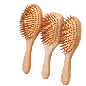 Wooden comb massage brush with beech wood handle and cushioned pins, suitable for gentle scalp brushing.