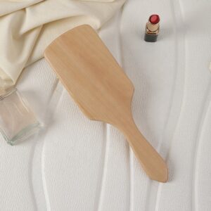 Massage comb with wooden handle and wood bristles, designed for scalp stimulation and daily hair care use.