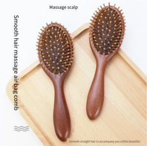 Round wooden hair brush made of sandalwood with air cushion and smooth pins for gentle scalp massage.