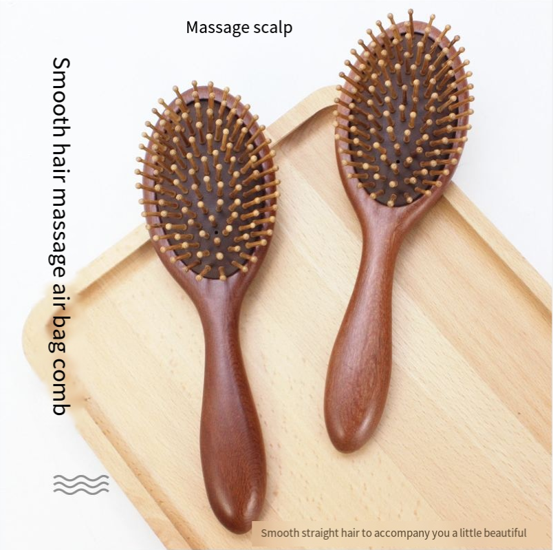 Round wooden hair brush made of sandalwood with air cushion and smooth pins for gentle scalp massage.