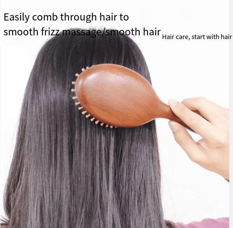 Round wooden hair brush made of sandalwood with air cushion and smooth pins for gentle scalp massage.