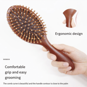 Round wooden hair brush made of sandalwood with air cushion and smooth pins for gentle scalp massage.