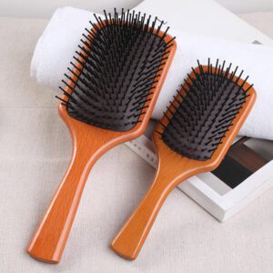 Wooden comb with rubber cushion base, designed as a comb massager for daily hair brushing.